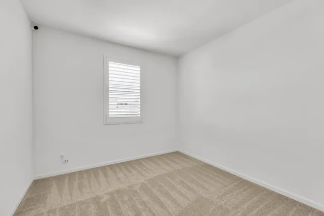 a bedroom with a bed and a potted plant