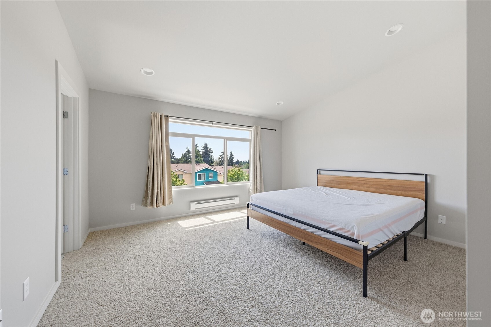 1066 Southwest 99th Place, Unit 55 Seattle, WA 98106 - Photo 14 of 21 a bed sitting in a room next to a window
