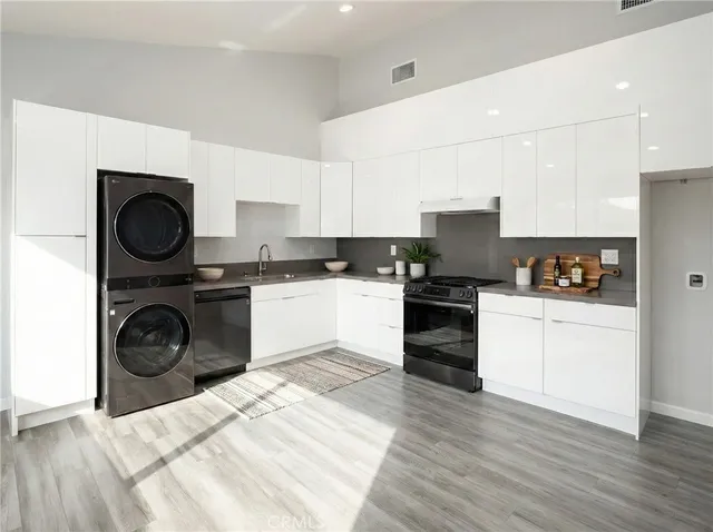a kitchen with a stove top oven and cabinets