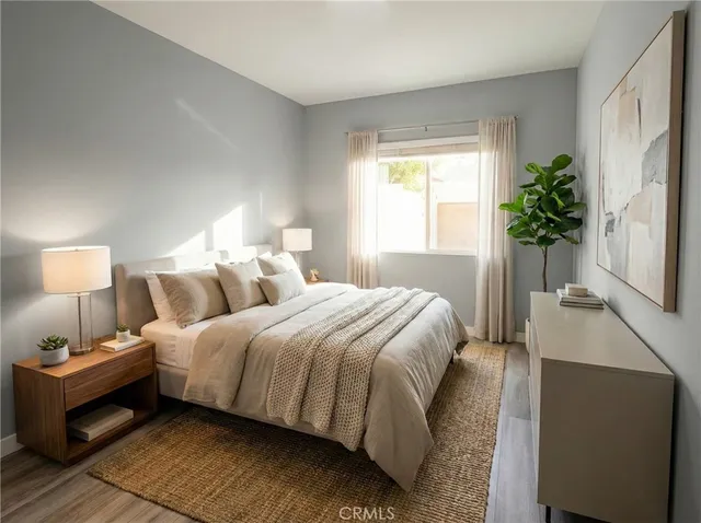 a bedroom with bed and a potted plant