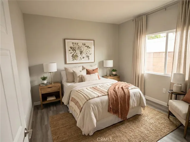 a bedroom with a bed and wooden floor