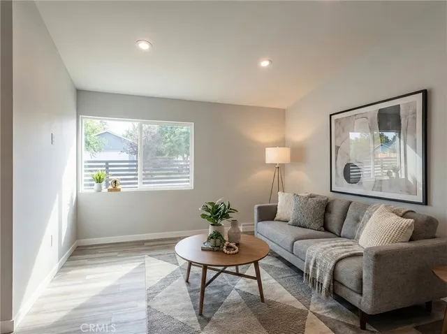 a living room with furniture and a potted plant