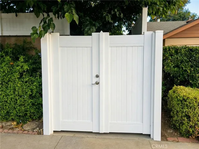 a view of white house with plants