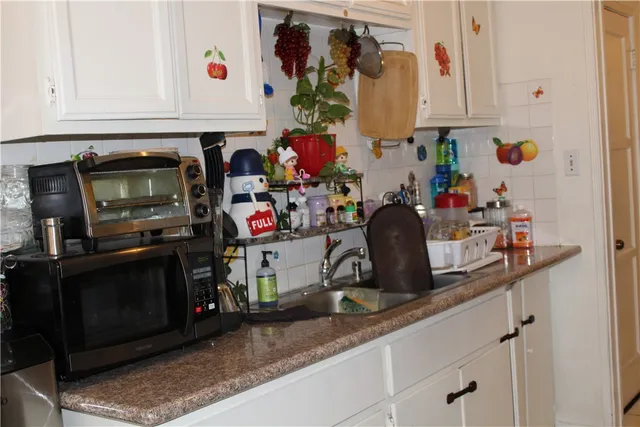 a kitchen with a sink and cabinets