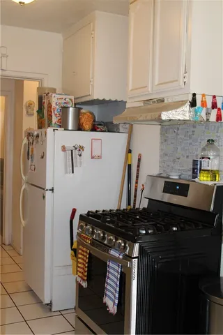a kitchen with stainless steel appliances granite countertop a refrigerator and a stove