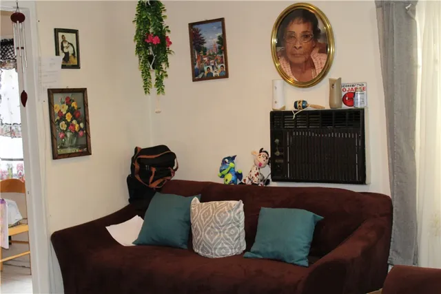 a living room with furniture and a mirror