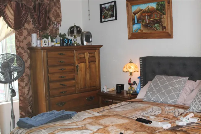 a bedroom with a bed and a dresser