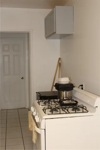 a stove top oven sitting inside of a kitchen