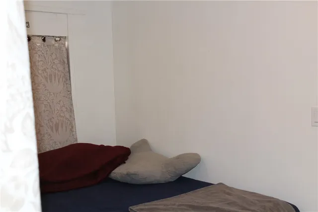 a living room with furniture a flat screen tv and a table