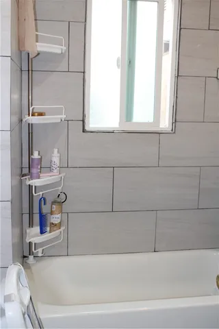 a bathroom with a window and a shower