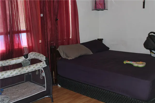 a bedroom with a bed and window