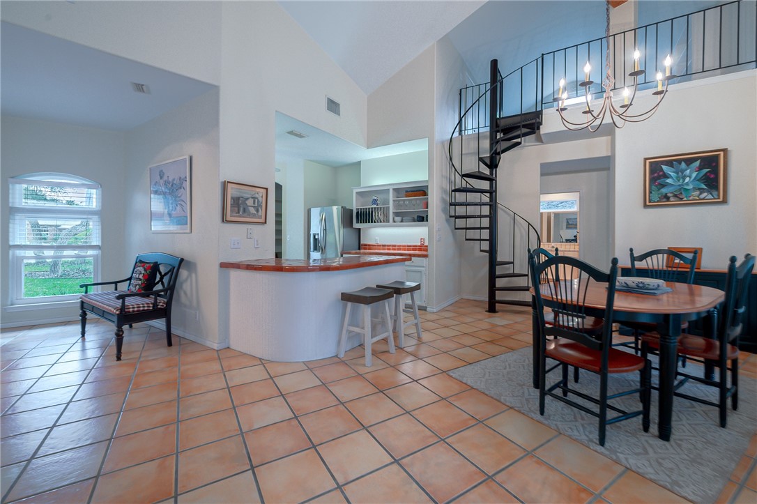 610 Bent Tree Street Rockport, TX 78382 - Photo 21 of 40 a living room with furniture a dining table and a stove top oven