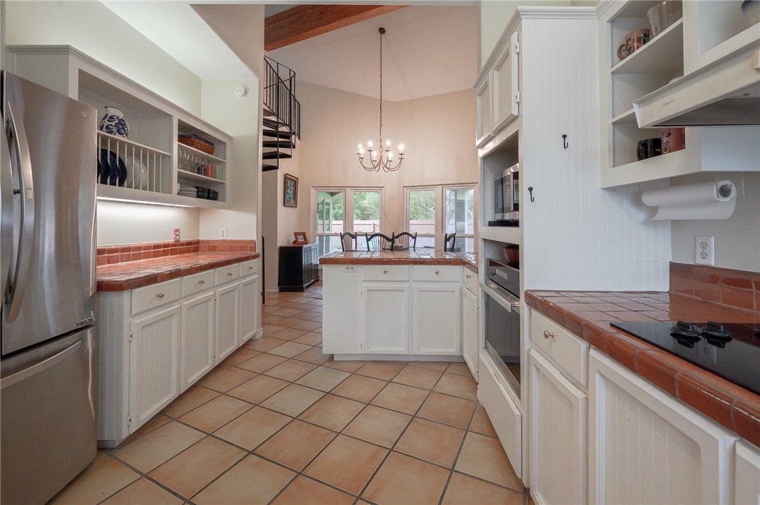 610 Bent Tree Street Rockport, TX 78382 - Photo 23 of 40 a kitchen with stainless steel appliances a sink and a refrigerator