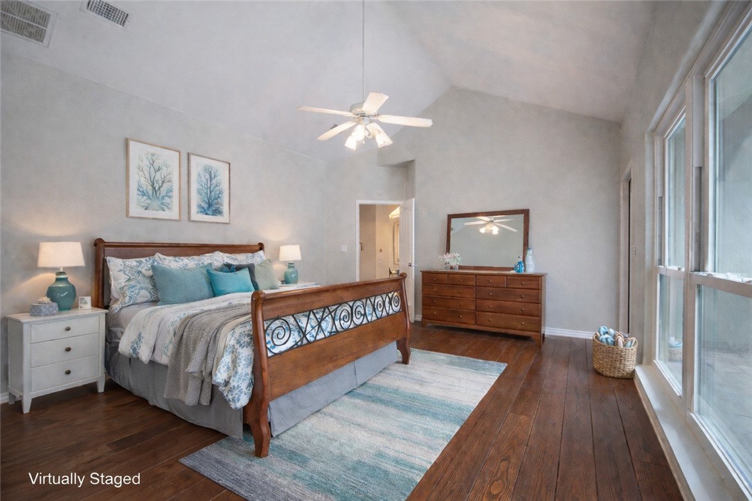 610 Bent Tree Street Rockport, TX 78382 - Photo 25 of 40 a bedroom with a bed and a chandelier
