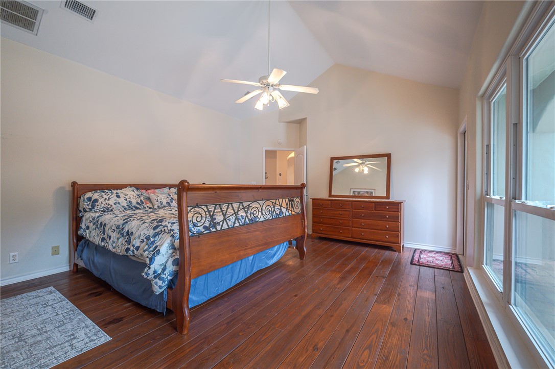 610 Bent Tree Street Rockport, TX 78382 - Photo 26 of 40 a bedroom with bed and wooden floor