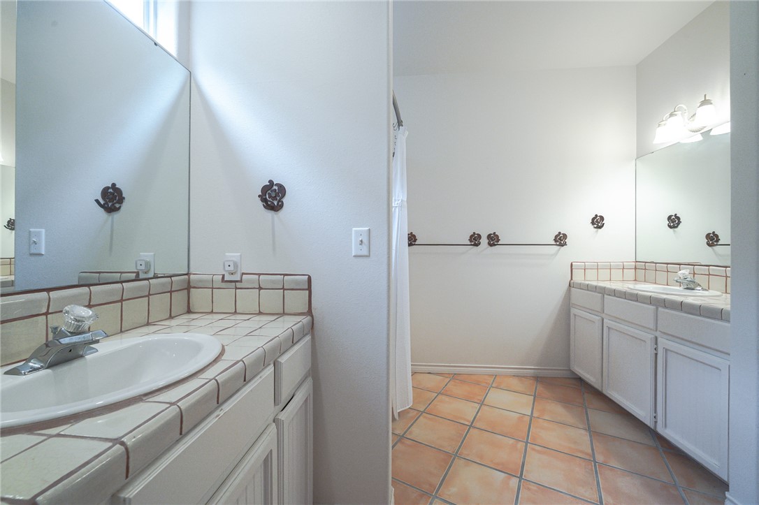 610 Bent Tree Street Rockport, TX 78382 - Photo 35 of 40 a bathroom with a sink a toilet and shower