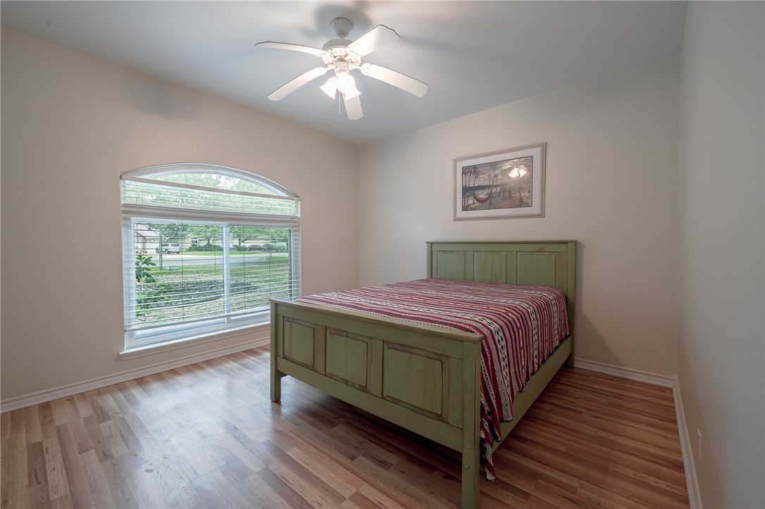 610 Bent Tree Street Rockport, TX 78382 - Photo 38 of 40 a bedroom with a large bed and a window