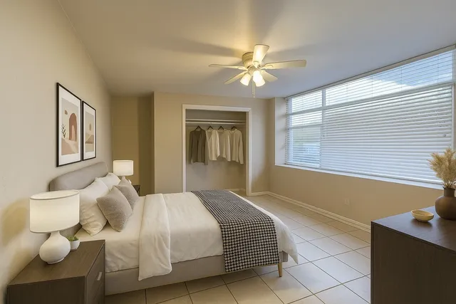 a bedroom with a bed and window