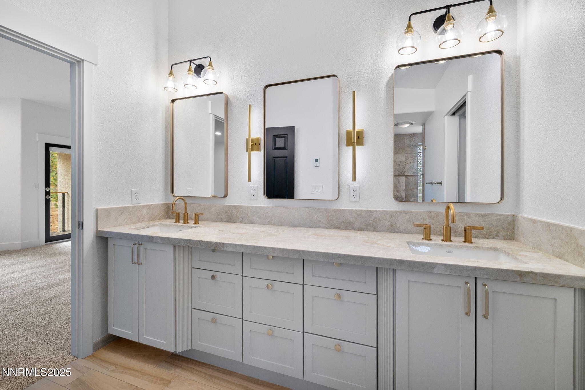 16435 Snow Flower Drive Reno, NV 89511 - Photo 21 of 48 a bathroom with a double vanity sink and a mirror