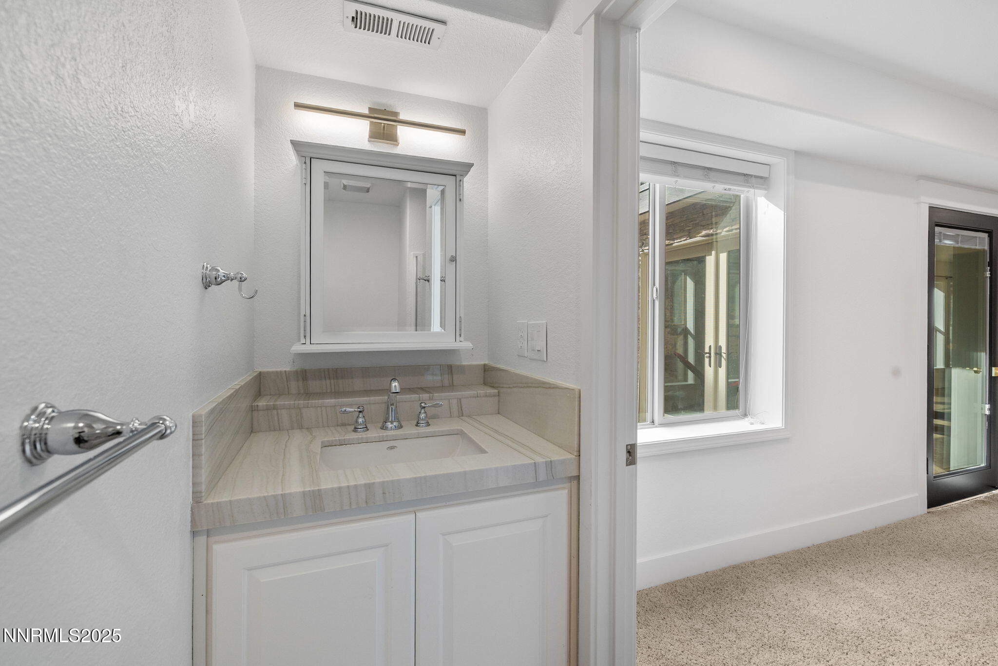 16435 Snow Flower Drive Reno, NV 89511 - Photo 33 of 48 a bathroom with a sink vanity and a mirror