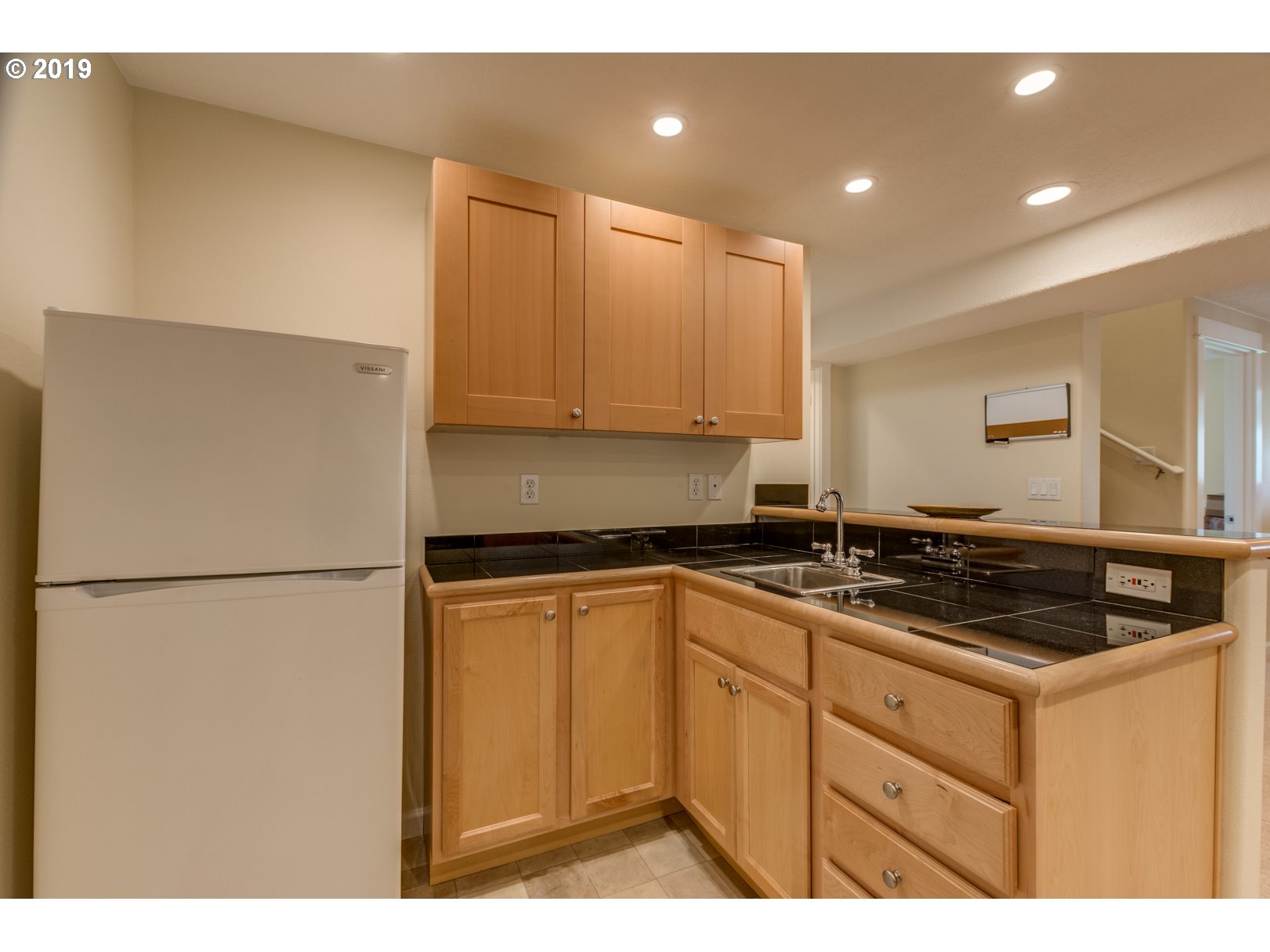 5859 Southwest Oleson Road Portland, OR 97225 - Photo 18 of 32 a kitchen with a sink a stove a refrigerator and cabinets
