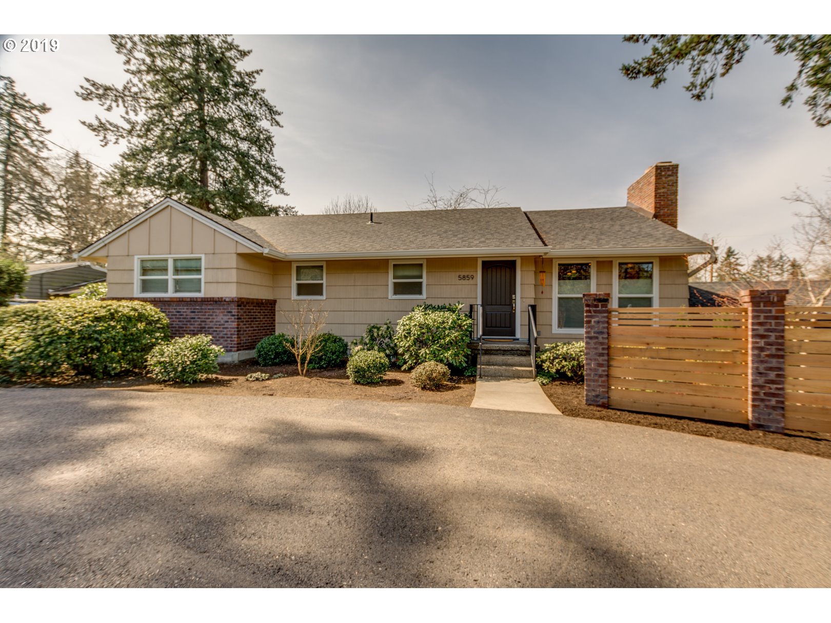 5859 Southwest Oleson Road Portland, OR 97225 - Photo 2 of 32 a view of a house with a small yard and large trees