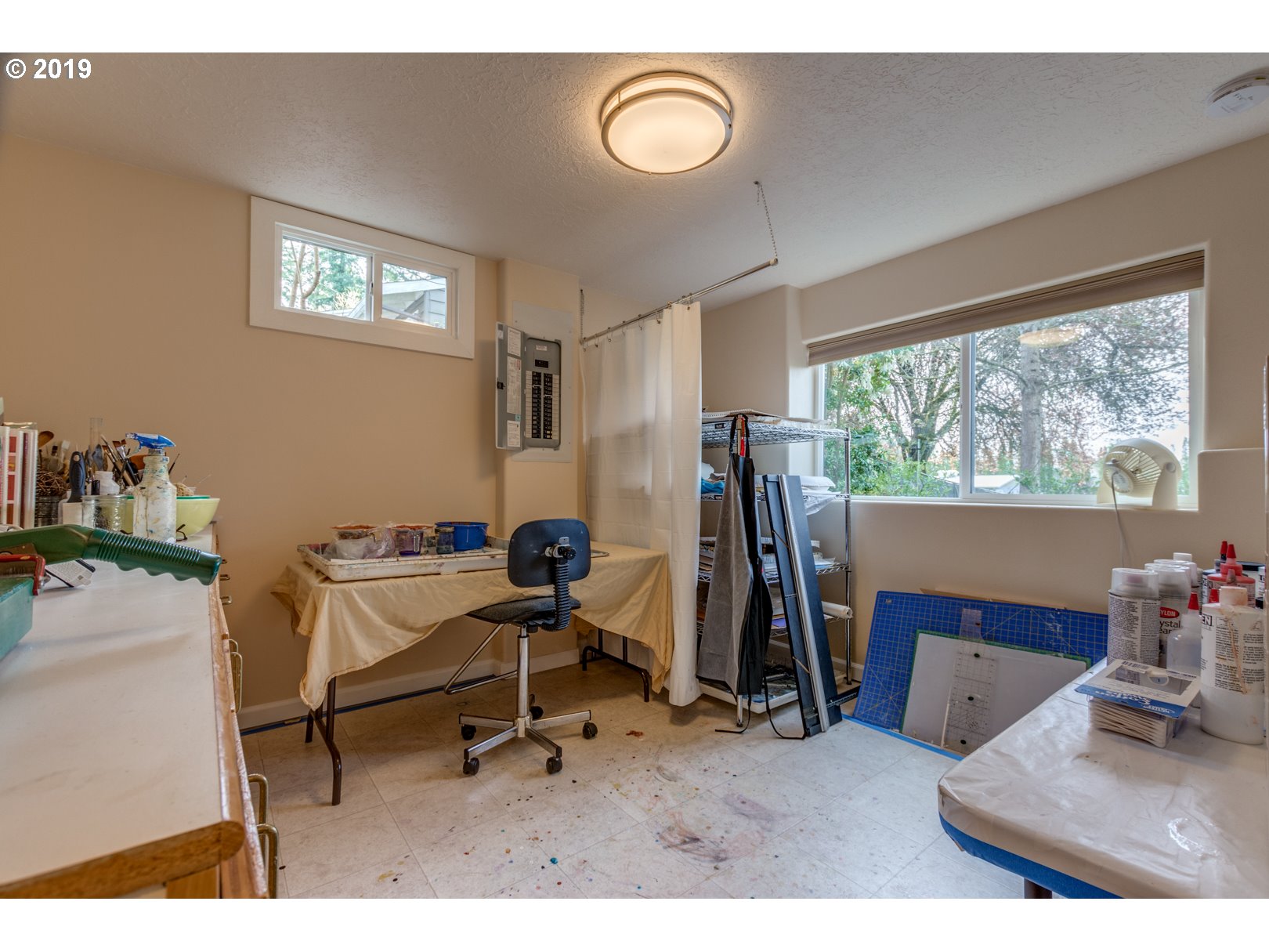 5859 Southwest Oleson Road Portland, OR 97225 - Photo 21 of 32 a view of a workspace with furniture and a window