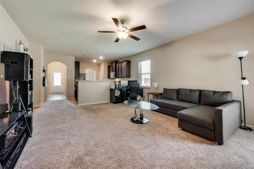 2213 Georgetown Street Princeton, TX 75407 - Photo 12 of 25 Living room with arched walkways, light colored carpet, and ceiling fan