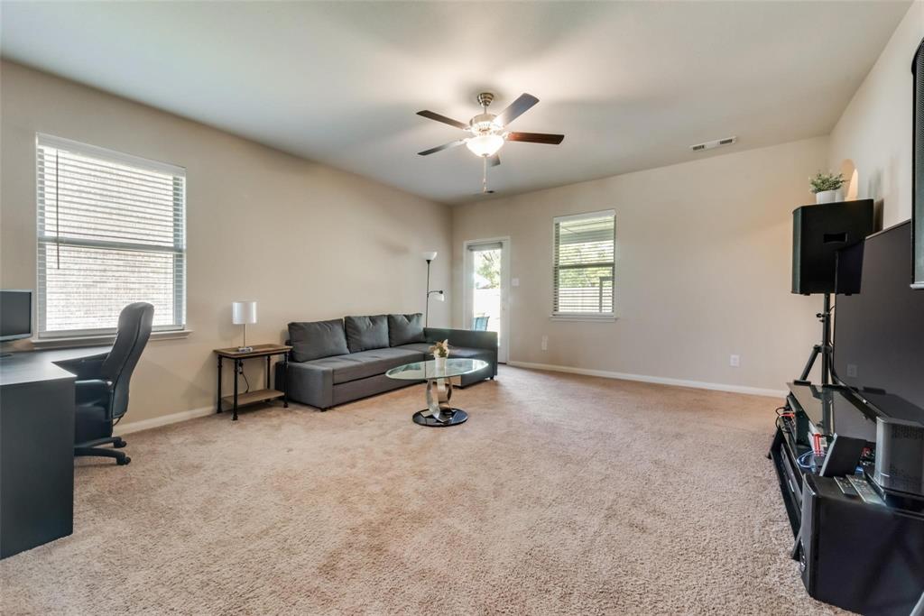 2213 Georgetown Street Princeton, TX 75407 - Photo 14 of 25 Living room with light colored carpet, a desk, and a ceiling fan