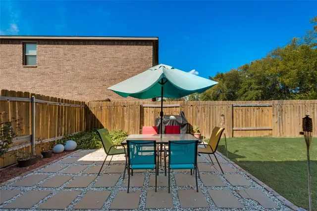 a patio with a table and chairs