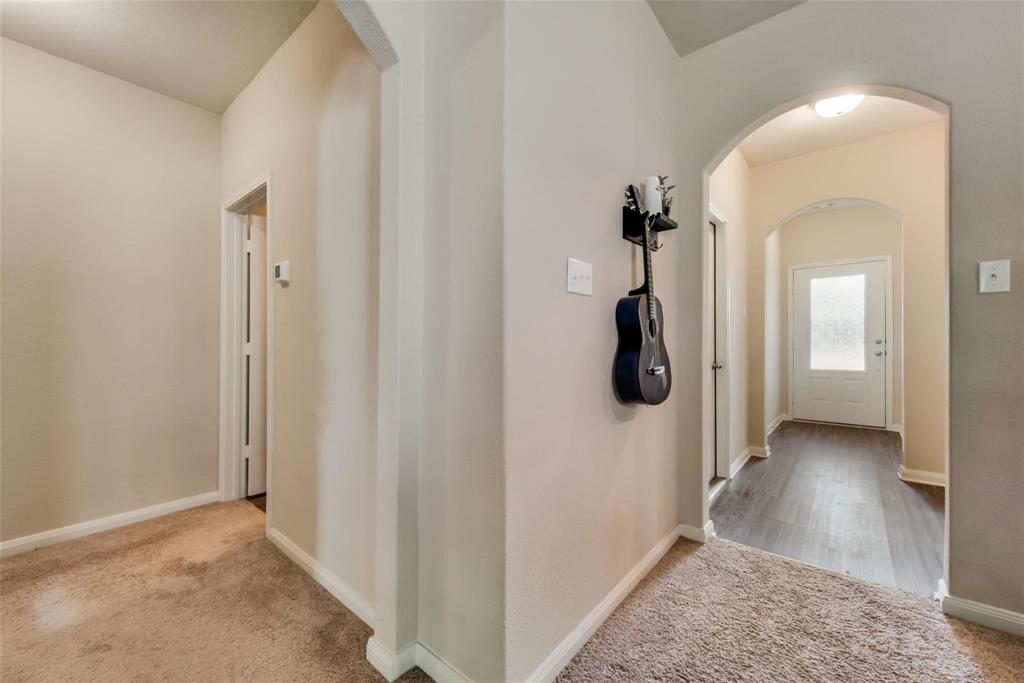 2213 Georgetown Street Princeton, TX 75407 - Photo 8 of 25 Hall with light colored carpet and arched walkways
