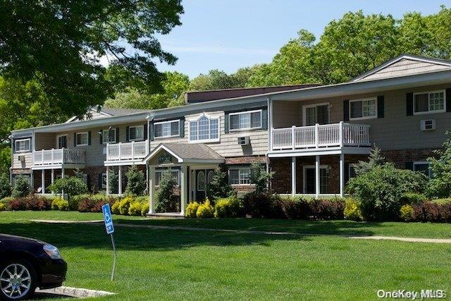 70 Mt Vernon Avenue, Unit D02 Patchogue, NY 11772 - Photo 1 of 1 a front view of a house with a yard table and chairs