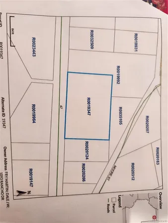 a utility room with dryer and white wall