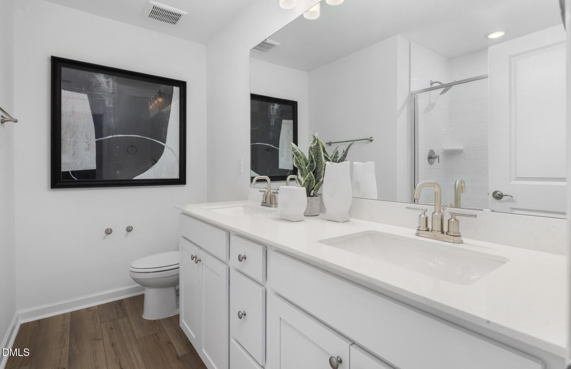 3034 Hammer Creek Road Durham, NC 27704 - Photo 10 of 19 a bathroom with 2 sink and a mirror