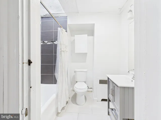 a bathroom with a toilet sink and shower