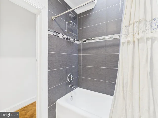 a bathroom with a shower and a bath tub