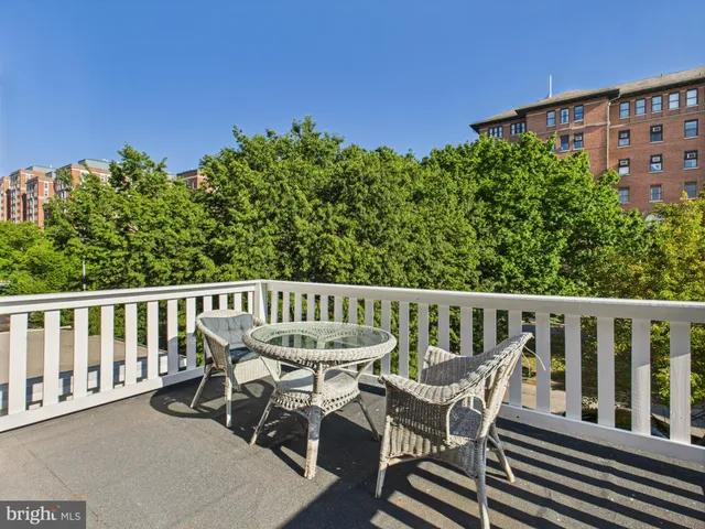 a view of a chair and table on the roof deck