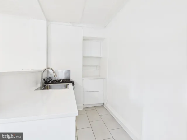 a close view of a sink and cabinets in kitchen