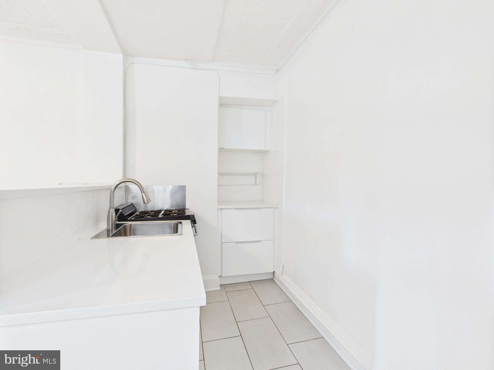 205 East 33rd Street, Unit 3 Baltimore, MD 21218 - Photo 15 of 18 a close view of a sink and cabinets in kitchen