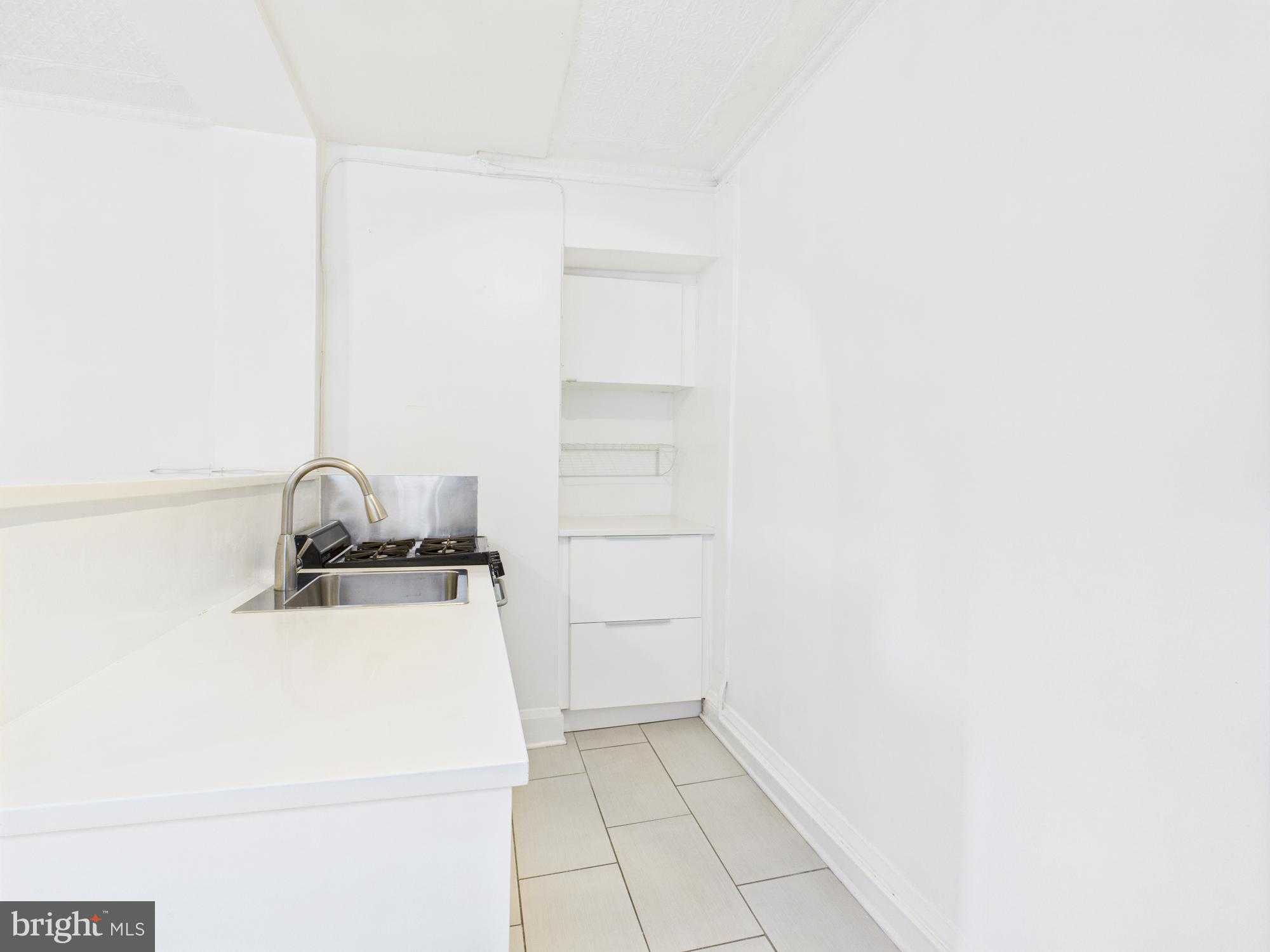205 East 33rd Street, Unit 3 Baltimore, MD 21218 - Photo 3 of 18 a bathroom with a sink