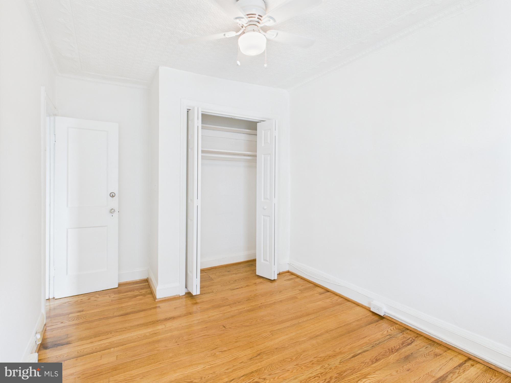 205 East 33rd Street, Unit 3 Baltimore, MD 21218 - Photo 6 of 18 a view of empty room with wooden floor