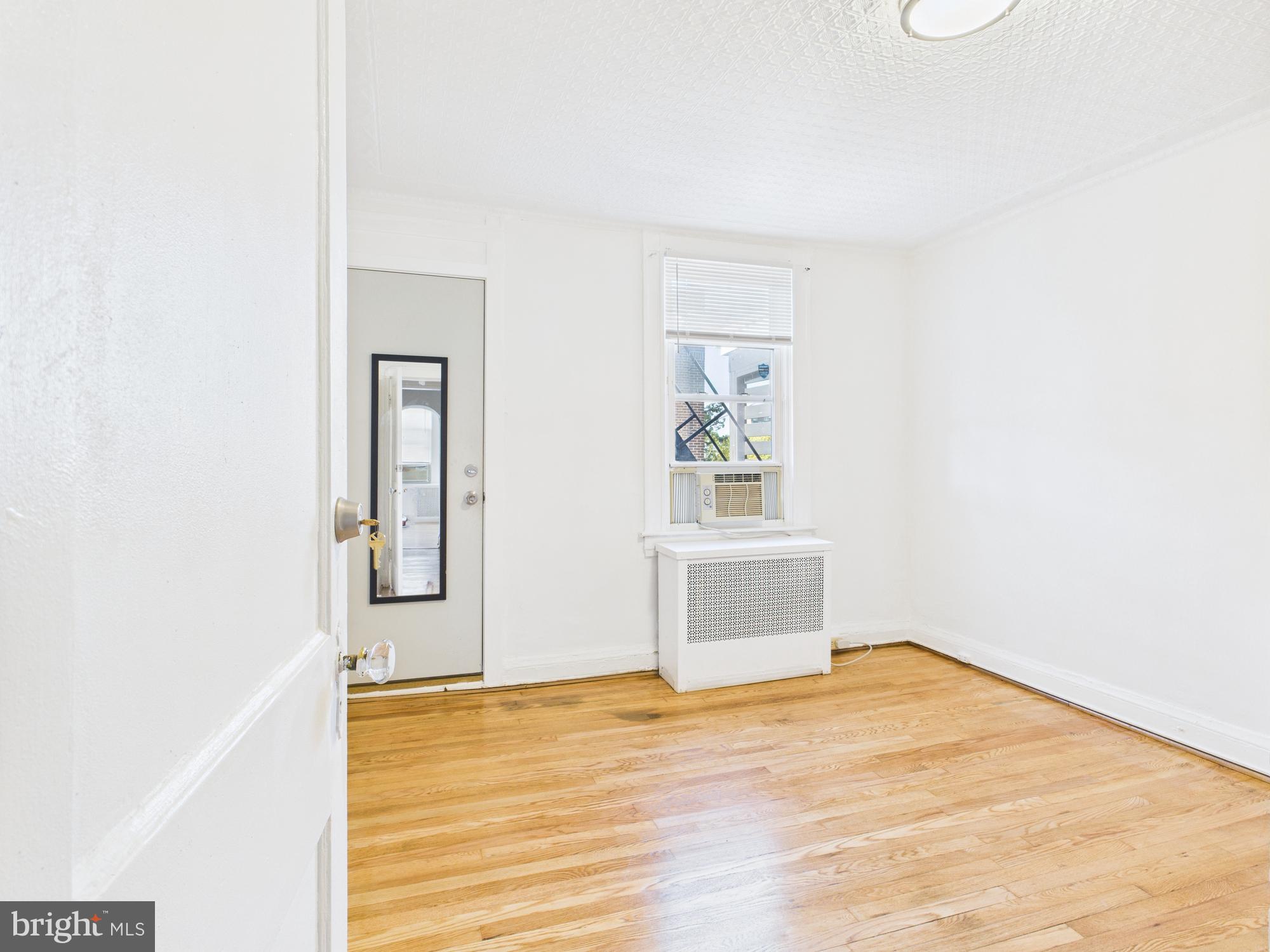 205 East 33rd Street, Unit 3 Baltimore, MD 21218 - Photo 7 of 18 a view of empty room with wooden floor