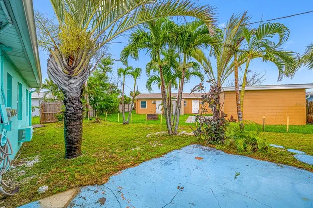 a spacious bedroom with a large bed and a chandelier fan
