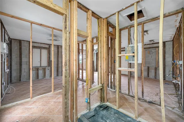 a dining room with stainless steel appliances furniture a refrigerator and a kitchen view