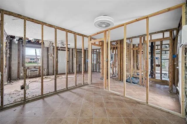 a kitchen with a stove a table and chairs in it