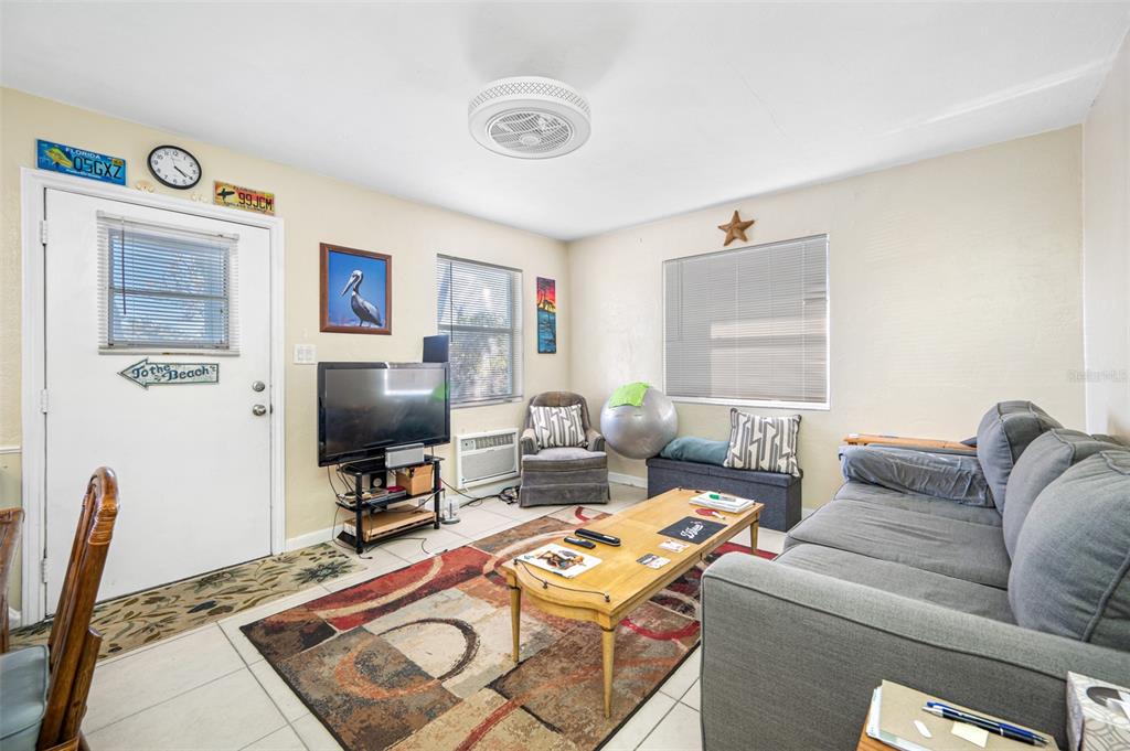 14111 West Parsley Drive Madeira Beach, FL 33708 - Photo 65 of 99 a living room with furniture and a flat screen tv