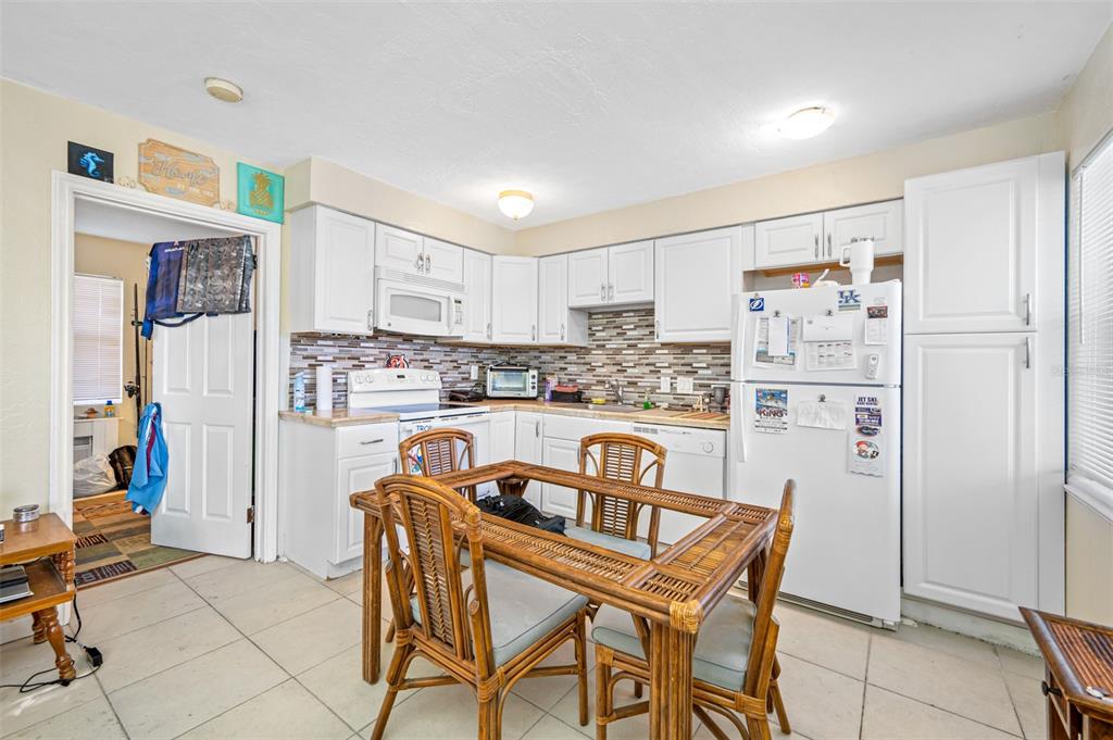 14111 West Parsley Drive Madeira Beach, FL 33708 - Photo 68 of 99 a kitchen with stainless steel appliances granite countertop a refrigerator and a stove top oven