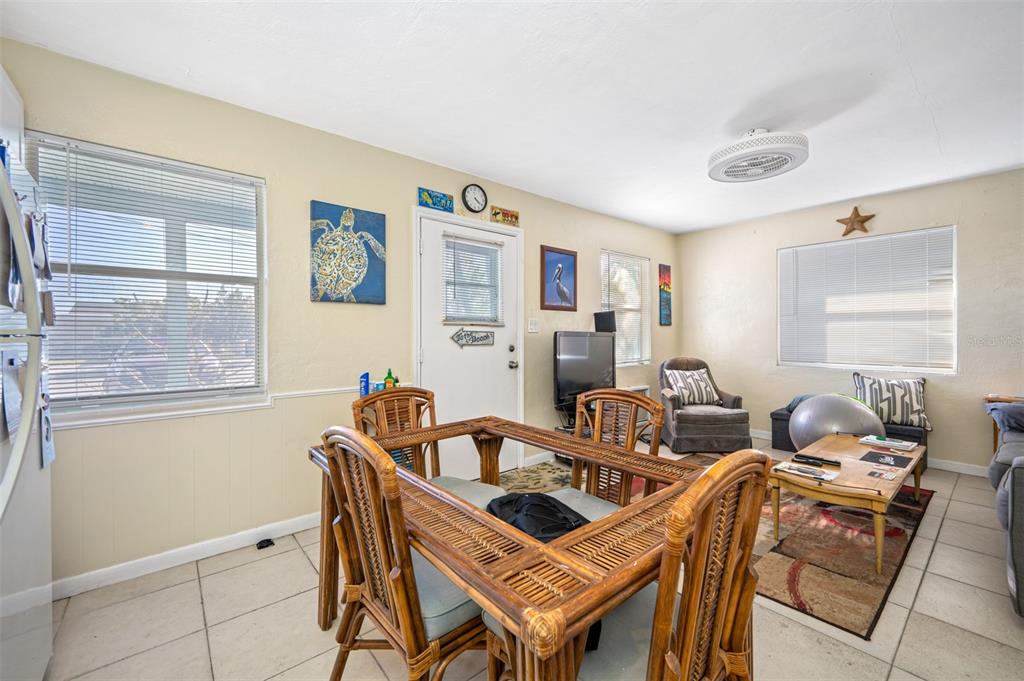 14111 West Parsley Drive Madeira Beach, FL 33708 - Photo 70 of 99 a view of a dining room with furniture a couch and wooden floor