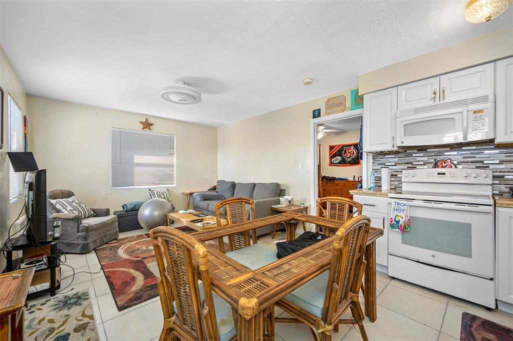 14111 West Parsley Drive Madeira Beach, FL 33708 - Photo 71 of 99 a work room with furniture a flat screen tv and a window