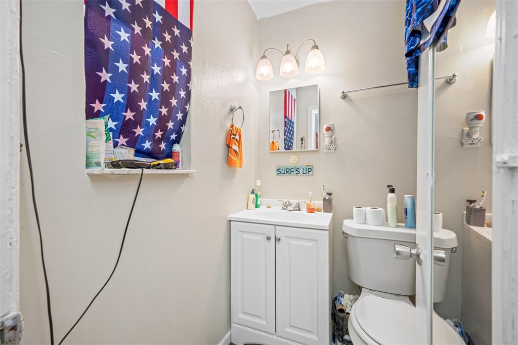 14111 West Parsley Drive Madeira Beach, FL 33708 - Photo 72 of 99 a bathroom with a sink toilet vanity and shower